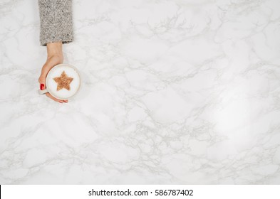 Woman Hands Holding Coffee Mug Or Cup On Colorful Table. Photograph Taken From Above, Top View With Copy Space