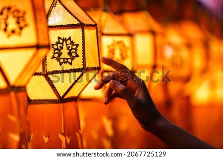 woman hands holding Colorful paper Lantern in lanna Yee Peng Festival (North of Thailand new years)