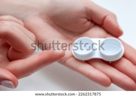 Woman Hands Holding Contact Eye Lens. Woman Hands Holding White Container. Beautiful Woman Fingers Holding Eye Lens Box. Contact Eye Lenses