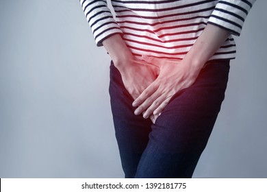 Woman with hands holding her crotch from bladder or uti pain.Symptom of cystitis-Healthcare and medical concept.