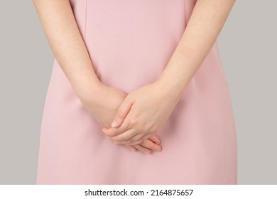 Woman hands holding her crotch suffering from pelvic pain or itchy. Gynecological problems include menstrual disorders, urinary incontinence, genital tract infections, STDs or ovarian cysts.
