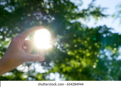 Woman Hands Holding Light Bulb With Solar Energy Or Thermal Energy Concept