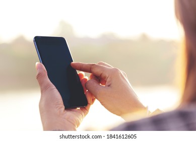 Woman Hands Holding Mobile Phone Outdoor Surfing Internet Online Technology Lifestyle. Close Up Woman Hand Using Smartphone Gadget Text Message Focus On Blank Smart Phone Screen. Technology Lifestyle