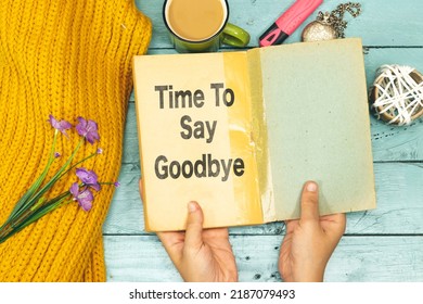 Woman Hands Holding An Old Book With Time To Say Goodbye Concept 