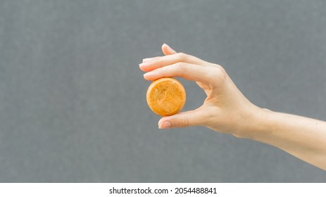 Woman Hands Holding Organic Soap Or Solid Shampoo With No Packaging Over Gray Background. Healthy Lifestyle, Beauty, Skin Care, Zero Waste Concept. Copy Space For Text