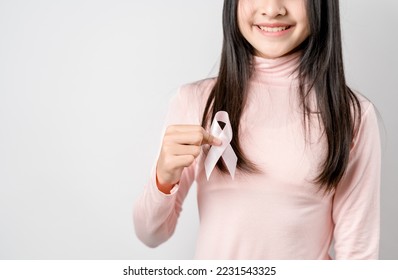 woman hands holding pink ribbon, Breast cancer awareness, world cancer day, national cancer survivor day in february concept.	 - Shutterstock ID 2231543325