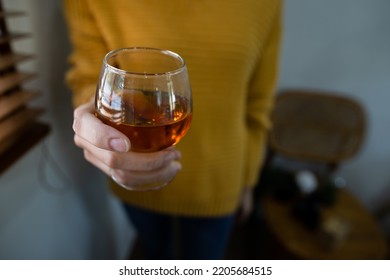 Woman Hands Holding Whiskey Glass.