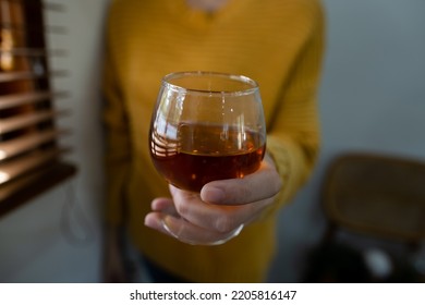 Woman Hands Holding Whiskey Glass.