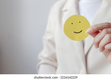 Woman Hands Holding Yellow Smile Face Paper, Good Feedback Rating,think Positive, Customer Review, Assessment, World Mental Health Day, Compliment Day.