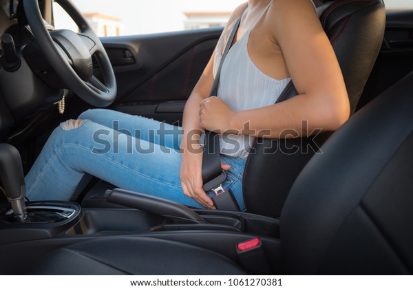 Woman Hands is Inserting Safety Belt in
Car Seat, Close-Up of Female Hand is Put on Seat Belt Before
Driving a Vehicle Car. Automobile Security Safe Mode System for
Personal Driver,
Transportation
