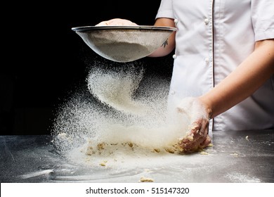 Woman hands kneading dough at kitchen