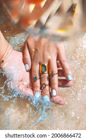 Woman Hands With Lots Of Rings In The Sea Wave Close Up 