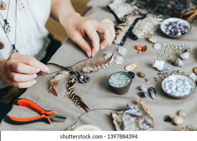 Woman hands making handmade gemstone jewelry, home workshop. Woman artisan creates jewelry. Art, hobby, handcraft concept