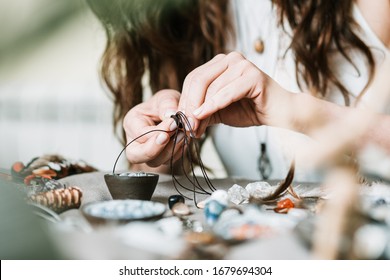 Woman hands making handmade gemstone jewellery, home workshop. Women artisan creates jewellery. Art, hobby, handcraft concept - Powered by Shutterstock