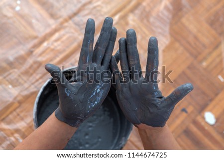woman hands mixing paint, human home activity, color dripping down,home repairs and refurbishments