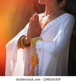 woman hands in mudra namaste gesture practice yoga outdoor day shot close up