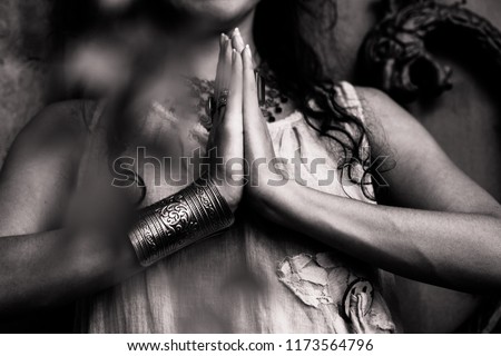woman hands in namaste gesture outdoor shot closeup 