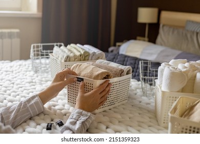 Woman Hands Neatly Folded Linens And Towels Use Marie Kondo Method With Sticky Label Tags Top View Closeup. Female Housewife Arms Sticking Names On Case Box For Comfortable Storage In Bedroom Closet