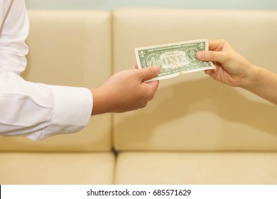 Woman Hands One Dollar Banknote For Tip To Waiter.