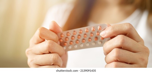 Woman hands opening birth control pills in hand. eating Contraceptive pill. Contraception reduces childbirth and pregnancy concept. Leave space to write descriptive text.