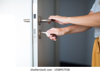 Woman Hands Opening A Door With Keys. Close Up. Hand Unlocks Key Lock Door. Coming Back Home.