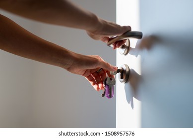 Woman Hands Opening A Door With Keys. Close Up. Hand Unlocks Key Lock Door. Coming Back Home.