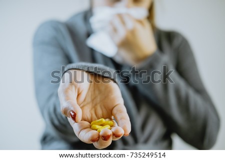 Woman hands with pills and a handkerchief. Cold concept
