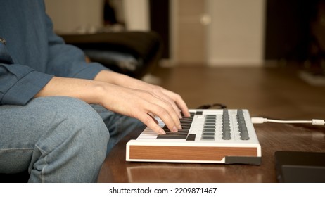 Woman Hands Playing On Small Keyboard, Producer Of Music. Closeup Of Hands Playing On Keys, Home Recording Studio With Professional Equipment. 