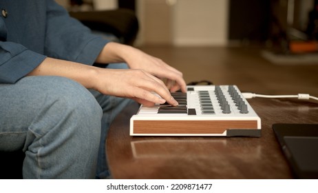 Woman Hands Playing On Small Keyboard, Producer Of Music. Closeup Of Hands Playing On Keys, Home Recording Studio With Professional Equipment. 