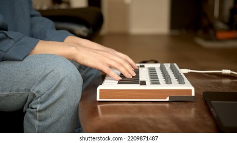 Woman Hands Playing On Small Keyboard, Producer Of Music. Closeup Of Hands Playing On Keys, Home Recording Studio With Professional Equipment. 