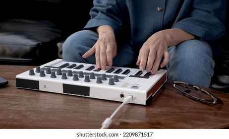 Woman Hands Playing On Small Keyboard, Producer Of Music. Closeup Of Hands Playing On Keys, Home Recording Studio With Professional Equipment. 