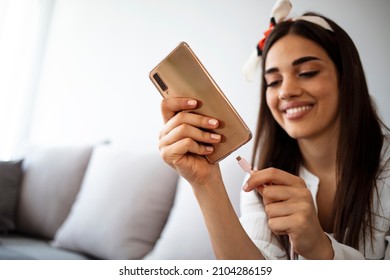Woman hands plugging a charger in a smart phone. Woman using smartphone with powerbank. Young woman charging power to smart phone. Woman charging battery on mobile phone at home