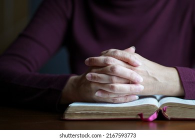 Woman hands in prayer posture on top of open bible. Copy space. - Shutterstock ID 2167593773