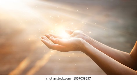 Woman hands praying for blessing from god on sunset background  - Shutterstock ID 1059039857