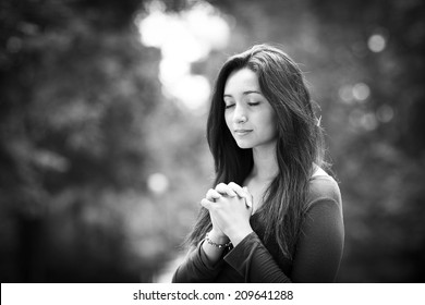 Woman hands praying on Outdoors black and white
