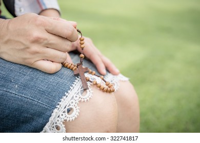 Woman Hands Praying With A Rosary