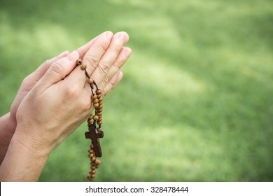 Woman Hands Praying With A Rosary