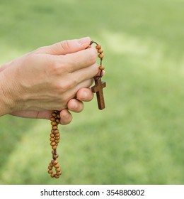 Woman Hands Praying With A Rosary