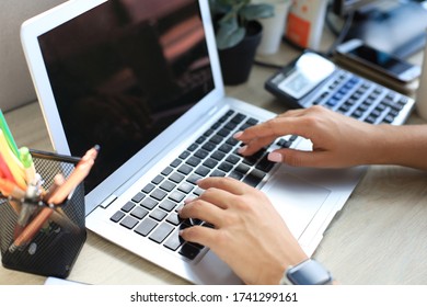 Woman Hands Pressing Keys On A Laptop Keyboard In Office.