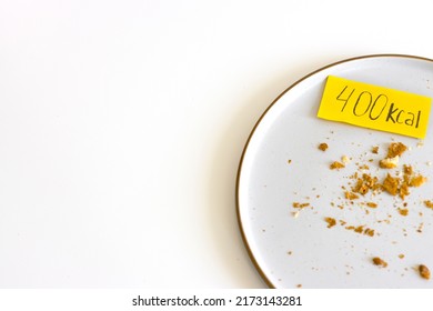 Woman Hands Put On Empty Plate With Crumbs Calories Label. Concept Counting Kcal, Food Control, Intuitive Eating, Breakfast, Copyspace.