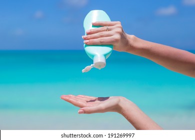 Woman Hands Putting Sunscreen From A Suncream Bottle