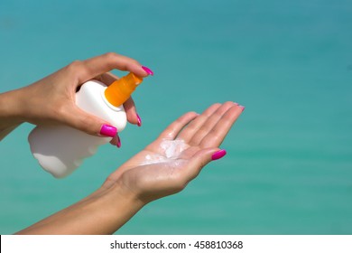 Woman Hands Putting Sunscreen From A Suncream Bottle