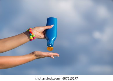 Woman Hands Putting Sunscreen From A Suncream Bottle