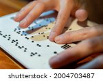 Woman hands reading braille text