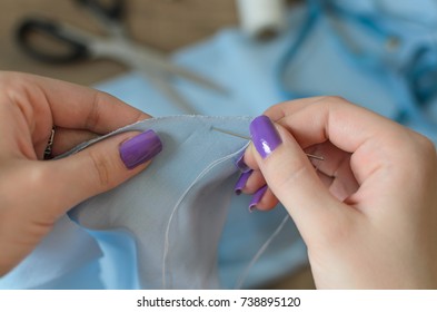 Woman Hands Sewing Blue Dress From Textile