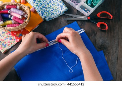 The woman hands sewing the clothing