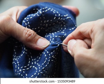 Woman Hands Sewing Running Stitch Blue Fabric. Traditional Japanese Sewing Pattern Call 