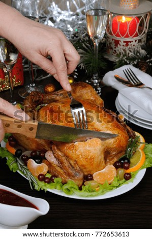 Woman hands slicing up tasty juicy spicy   appetizing  roasted whole chicken