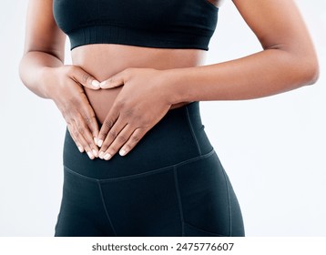 Woman, hands and stomach health in studio with digestion, progress and detox diet for gut wellness. Female person, abdomen and body goal, weight loss and nutrition balance on white background