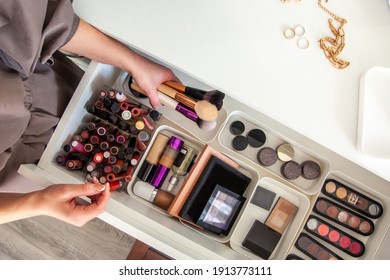 Woman Hands Is Taking Out Makeup Brush Set From The Drawer Of Vanity Table. Concept Of Decluttering And Organizing Of Beauty Cosmetics And Makeup Kit With MUJI's PP Makeup Boxes. Copy Space